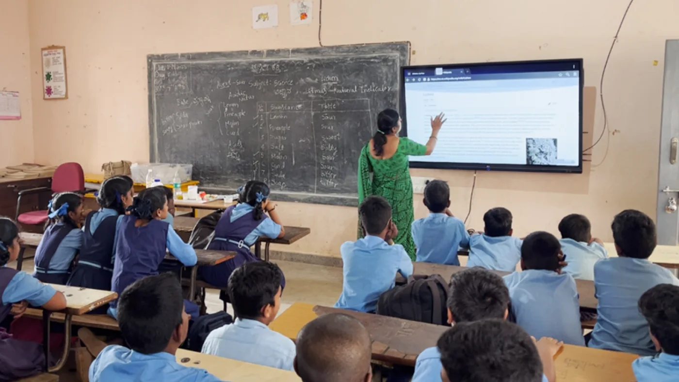Students and a teacher learning together at Gayathri Higher Primary School