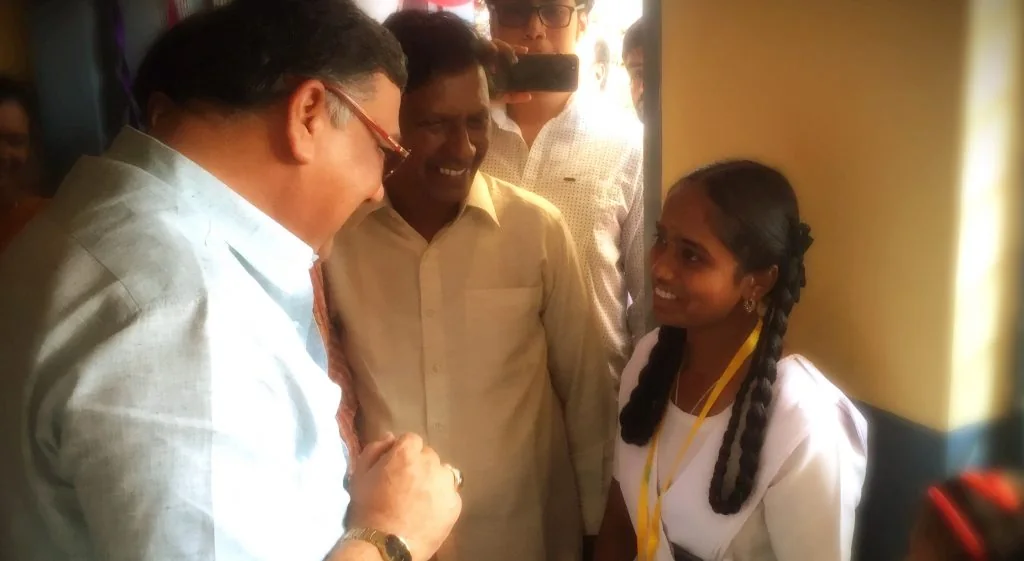 A visiting Education Minister listening to a student